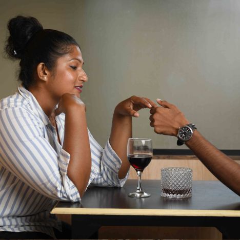 A couple sharing a tender moment at Mon Ami City Hotel, featuring stylish furnishings and a warm ambiance.