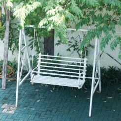 A swing positioned in the center of a yard, inviting relaxation at the Mon Ami City Hotel.