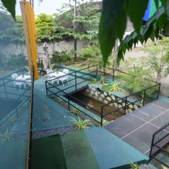 Balcony view showcasing a pool, with the charming facade of Mon Ami City Hotel in the background.