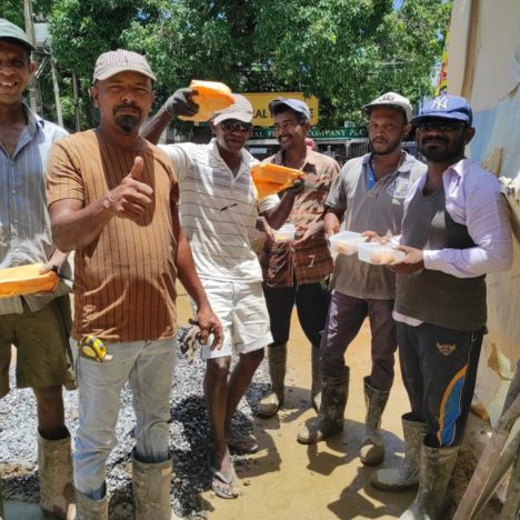 Food donation from Mon Ami City Hotel to construction workers, highlighting the hotel's commitment to community welfare.